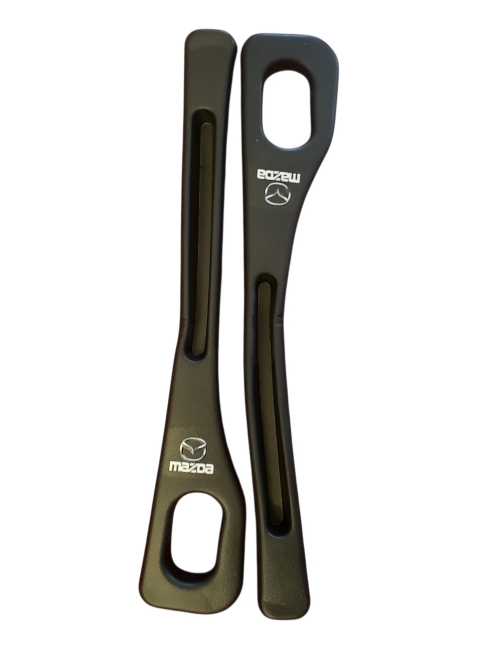 Mazda branded in black plastic inserts are designed as car seat gap fillers.